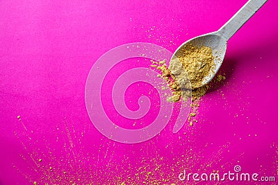 Golden yellow seasoning powder in wooden spoon for gourmet cuisine Stock Photo