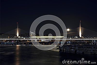 Goldenhorn and metro bridge view at dusk with full moon in istanbul at winter season. Editorial Stock Photo