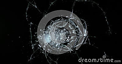 Golf Ball breaking Pane of Glass against Black Background Stock Photo