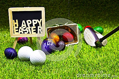 Golf ball with Easter eggs on green grass Stock Photo