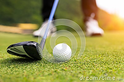 Golf ball on green grass ready to be struck at golf club Stock Photo