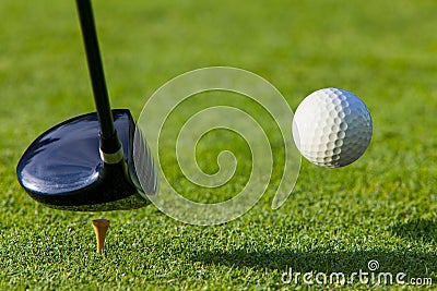 Golf ball hit off the tee with driver on golf cour Stock Photo