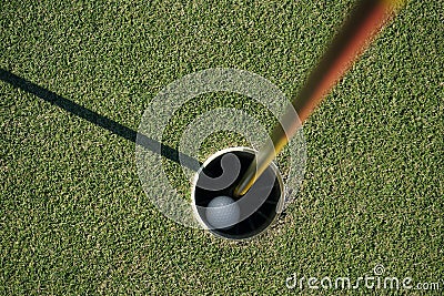 Golf ball is beside the hole Stock Photo