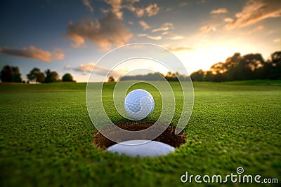 Golf Ball near hole Stock Photo