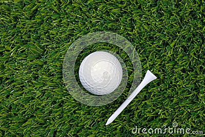 Golf ball and tee on grass Stock Photo