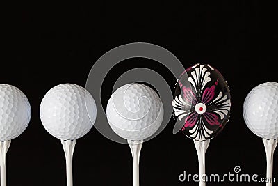 Golf balls and egg on a black glass desk Stock Photo