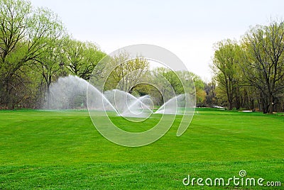 Golf course fairway being watered Stock Photo