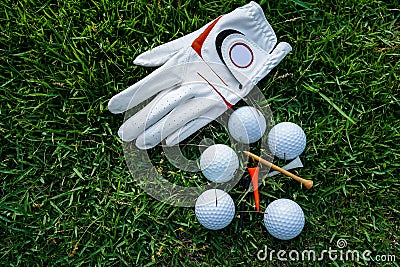 Golf equipment on green grass, ball, glove, tee and golf-club driver, golf gear and equipment on flat lay top view Stock Photo