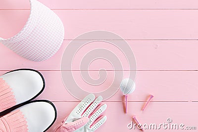 Golf equipment for ladies on a wooden surface in pink, top view Stock Photo