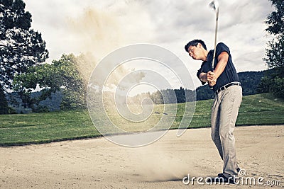 Golf player in sand trap. Stock Photo