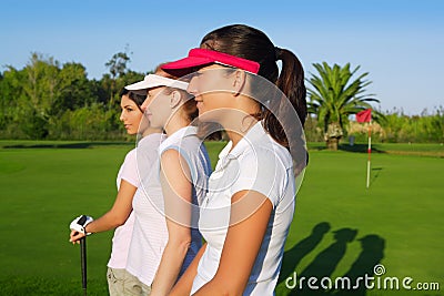 Golf three woman in a row green grass course Stock Photo