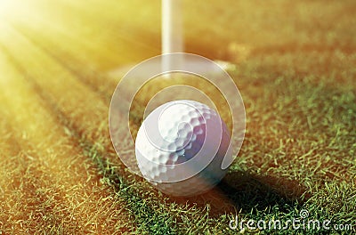 Golfball in front of the hole Stock Photo