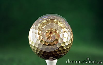 Golfball in gold Stock Photo