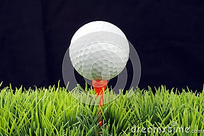 Golfball on tee Stock Photo