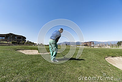 Golfer Hitting Ball with Club Editorial Stock Photo