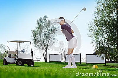 Golfer hitting golf ball Stock Photo