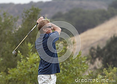Golfer at Swing Finish Stock Photo