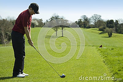 Golfer teeing off Stock Photo