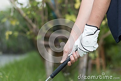 Golfer wearing white glove holdiing golf club Stock Photo