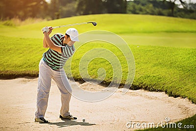 Golfers looking to hit the ball Stock Photo