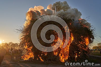 The Easter fire is lit in front of a crowd of spectators Editorial Stock Photo