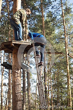 Gomel, Belarus - 30 April, 2017: Rope town for a family holiday in the countryside. Family competition to overcome aerial obstacle Editorial Stock Photo