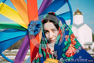 Portrait of unknown beautiful young woman girl in headscarf on her head at Celebration of Maslenitsa Shrovetide holiday Editorial Stock Photo