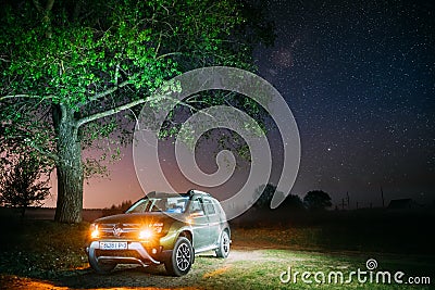 Night Starry Sky Above Car Renault Duster. SUV parked near lonely tree in night forest. Editorial Stock Photo