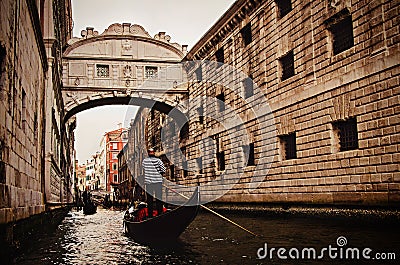 Gondola boat passing underneath the famous Bridge of Sighs in Venice Editorial Stock Photo