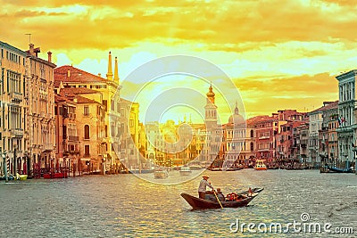 Gondola with gondolier near Rialto Bridge Grand Canal in Venice, Italy during sunset. Venice postcard. Tourism concept. Editorial Stock Photo