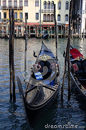 Gondola moored at the jetty ready to navigate the canals Stock Photo