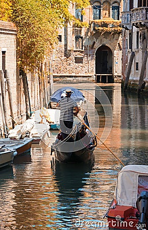 Gondola sails in a canal in autumn day in Venice Editorial Stock Photo