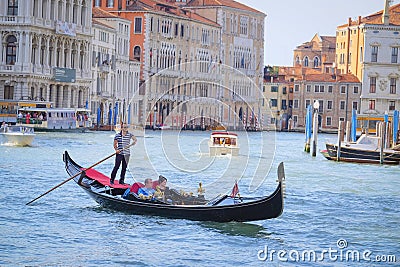 Gondola sails down the channel in Venice Editorial Stock Photo