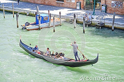 Gondola sails down the channel in Venice Editorial Stock Photo