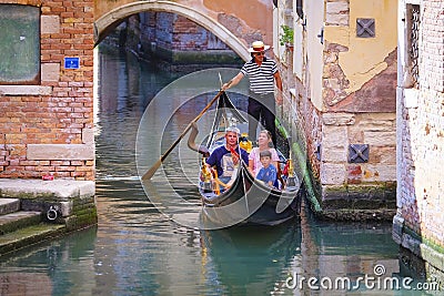 Gondola sails down the channel in Venice Editorial Stock Photo