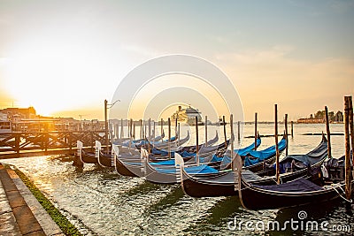 Gondolas of Venice Italy in the morning against the backdrop of sunrise Editorial Stock Photo