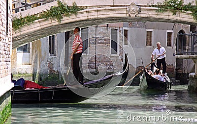 Gondolier, gondola and tourists in Venice Editorial Stock Photo