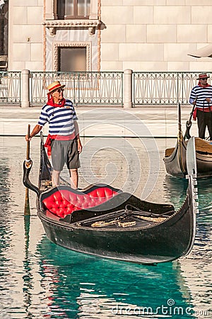 gondolier offers his shipping servive at the Venetian hotel in Las Vegas to tourists with the replica of a venetian gondola Editorial Stock Photo