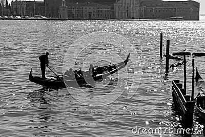 Gondolier rowing tourists in a gondola Stock Photo