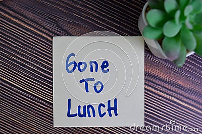 Gone To Lunch write on sticky notes isolated on Wooden Table Stock Photo