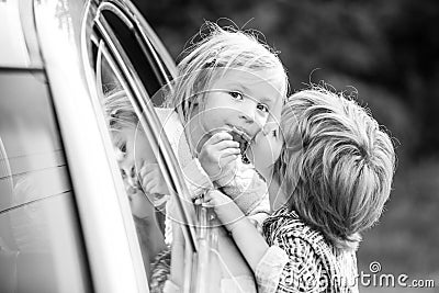 Good bye before car travel. Cute children saying goodbye before car travel. Stock Photo