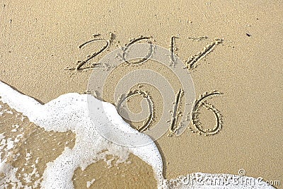 Good bye 2016 hello 2017. inscription written in the beach sand. Stock Photo