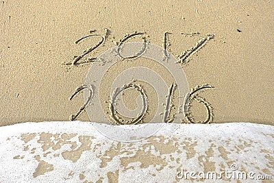 Good bye 2016 hello 2017. inscription written in the beach sand. Stock Photo