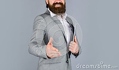 Good deal. Pleasant cheerful handsome realtor shaking hands. bearded man working in office. Portrait of successful Stock Photo