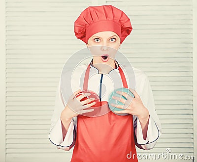 Good food for good health. cook in restaurant, uniform. girl in apron and hat hold bowls. professional chef cooking in Stock Photo