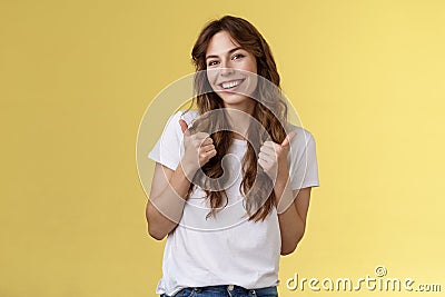 Good have my support. Cheerful positive cute lively curly-haired european girl show thumbs-up approval like gesture tilt Stock Photo
