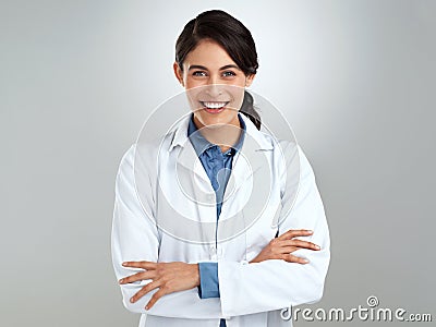 Good health makes good sense. Studio portrait of a confident young doctor posing against a grey background. Stock Photo