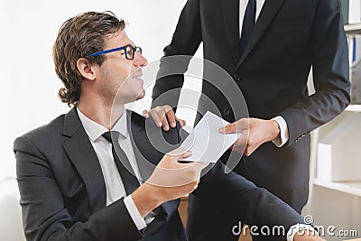 Good job, asian manager man giving financial reward in an envelope, business letter extra salary to company employee, caucasian Stock Photo