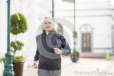 Active mature man jogging in the city Stock Photo