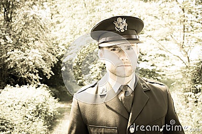 Handsome American WWII GI Army officer in uniform walking through woods Stock Photo